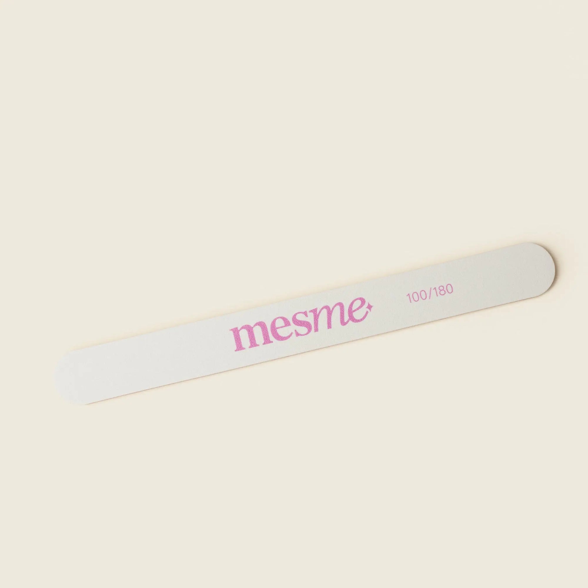 Nail file with 'mesme' branding on a beige background