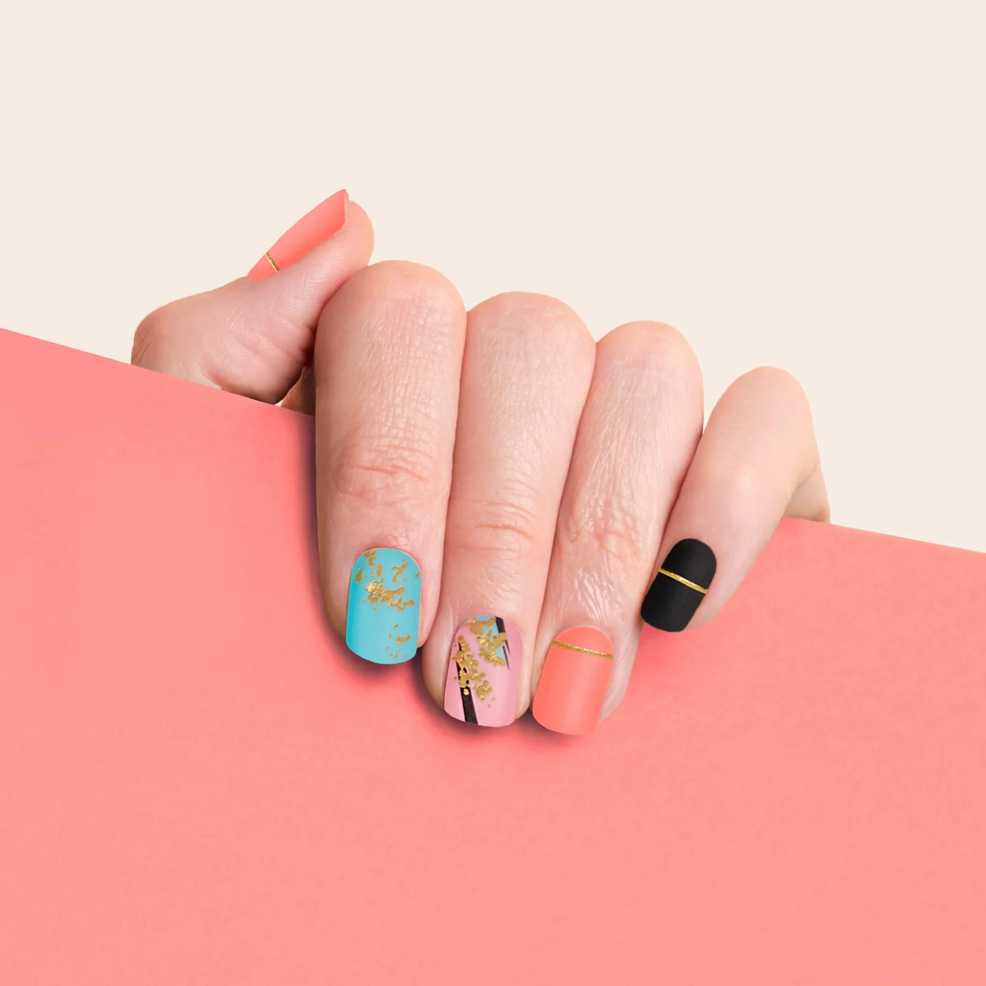 mesme Yayoi Turquoise, Coral, Pink, and Black 3+ Day UV-Free Gel Nail Wraps On Hand